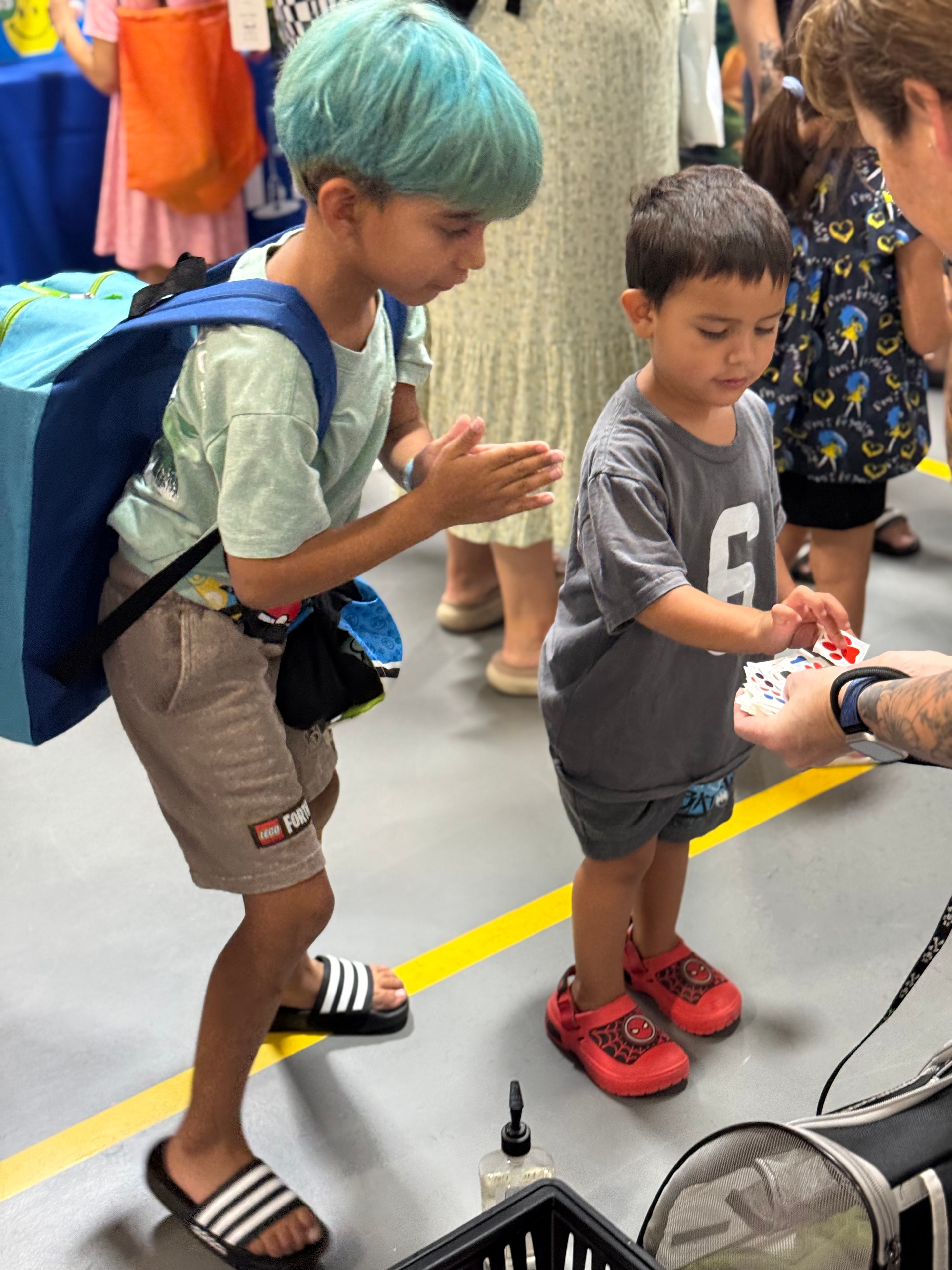 Children enjoying a magic card trick at the Back to School Health Fair