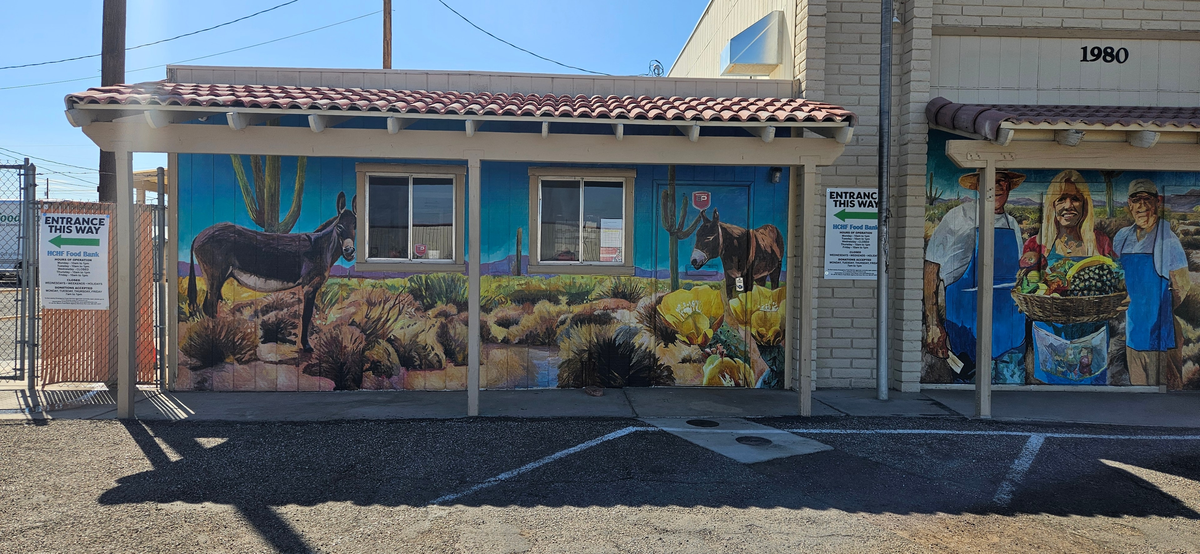 Food bank exterior mural with desert landscape and burros